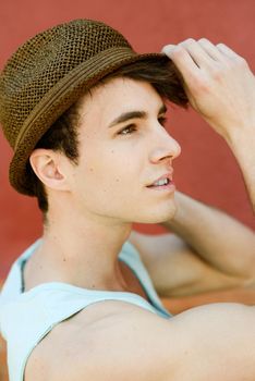 Portrait of a young handsome man, model of fashion, with modern hairstyle in urban background