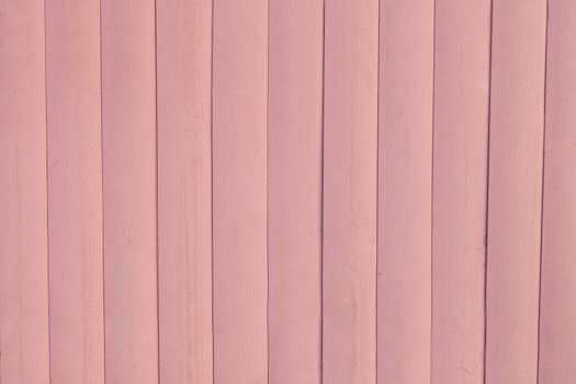 Painted Light Pink Rustic Wood Board Background. Space for text- timber ground of painted plank. Horizontal Tinted photo.