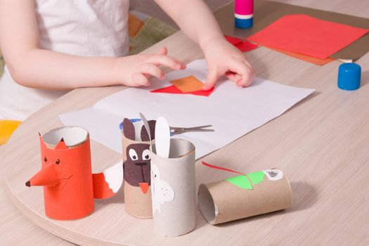 crafts from colored paper and toilet paper bushings, what to do with the child at home, development of imagination and fine motor skills of the hands, the child makes an application