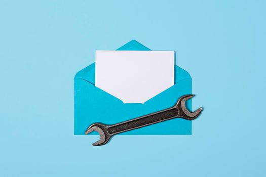 Happy father's day banner with copy space. Man or husband concept. Blue Envelope and wrench on blue background. Happy labor day.