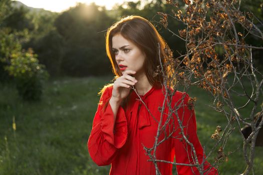 attractive woman in red dress outdoors fresh air summer. High quality photo