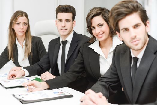 Image of business team looking at camera in working environment