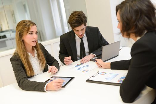 Image of business partners discussing documents and ideas at meeting