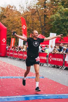 POLTAVA, UKRAINE - 1 SEPTEMBER 2019: A happy man reaches finish line during Nova Poshta Poltava Half Marathon.