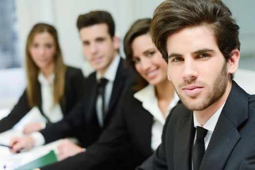 Image of business leader looking at camera in working environment