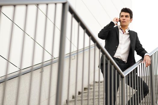 Portrait of a young businessman in an office building talking on the phone