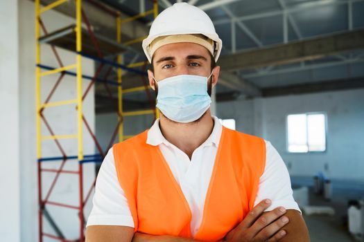 Portrait of young construction engineer wearing hardhat, close up