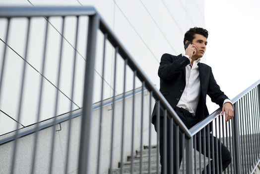 Portrait of a young businessman in an office building talking on the phone