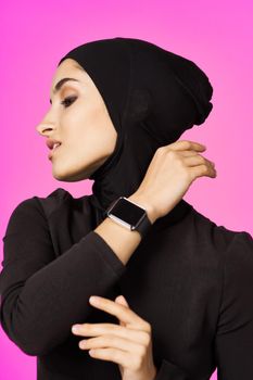 muslim woman in black hijab smart watch technology entertainment. High quality photo