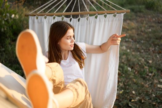 woman relaxing in nature in a hammock garden fresh air. High quality photo