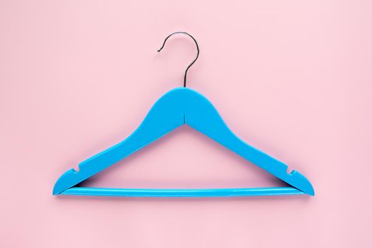 Wooden blue hanger with black paper label isolated on pink paper background. Clothing tag, label blank mockup template, to place your design. Black friday final sale banner.