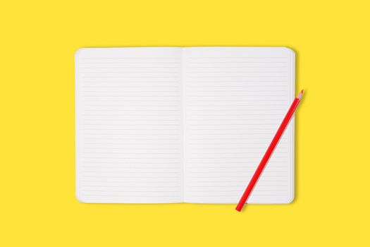 School or office notebook with red pencil isolaed on yellow background. Top view. Mock up