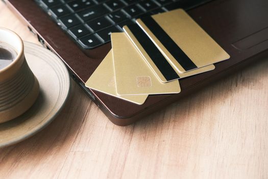 high angle view of credit cards on laptop on table .