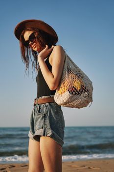 woman walking on the beach landscape sun fun lifestyle. High quality photo