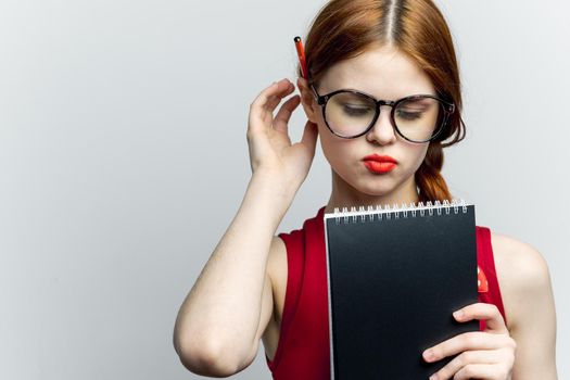 woman secretary in glasses with a notebook in the hands of the manager. High quality photo