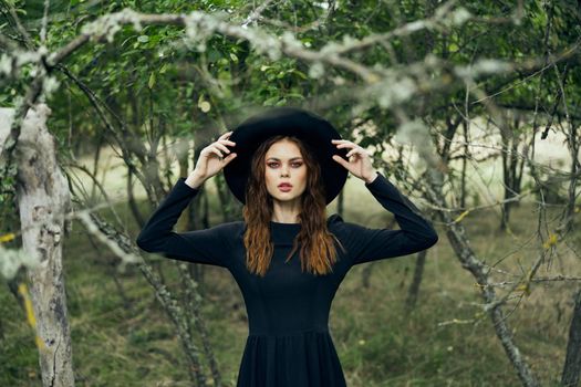 witch in the woods posing costume halloween gothic style. High quality photo