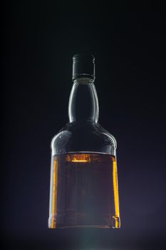 Bottle of whisky on black background
