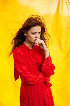 pretty woman in red dress nature yellow cloth on background. High quality photo