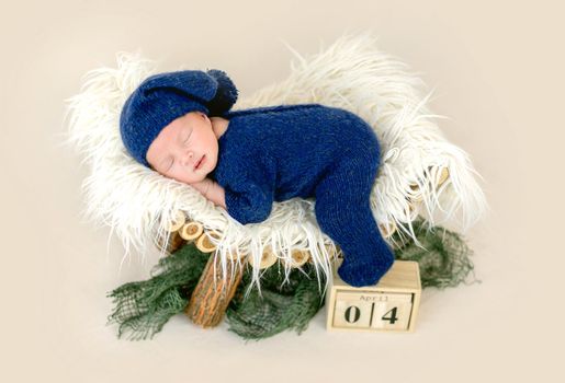 Beautiful newborn sleeping on pedestal