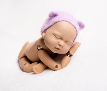 Realist puppet of newborn child in taco stand with hat, isolated on white background