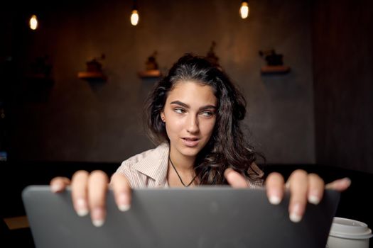 woman sitting in cafe in front of laptop working technology. High quality photo