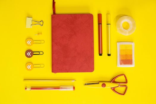 School supplies. Yellow and red colors. Flat lay composition. Yellow background. Space for text. Back to school.