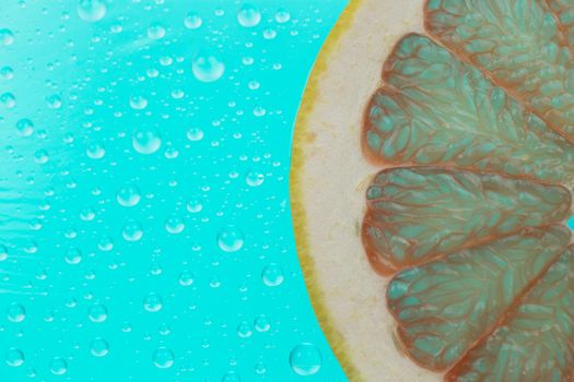 grapefruit slice on green background