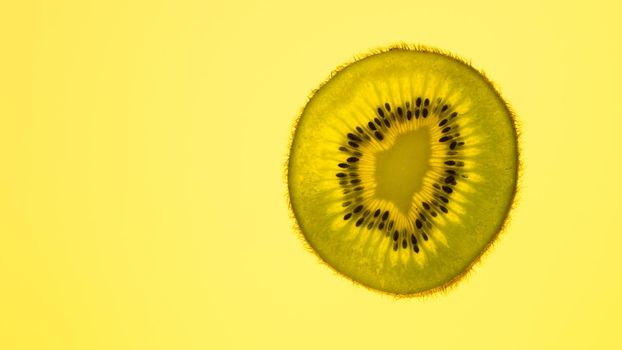 kiwi slice on yellow background