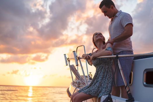 Loving couple spending time on a yacht at the open sea