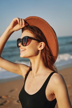 cheerful woman in sunglasses Sandy coast landscape sun. High quality photo