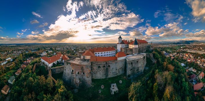 Aerial view of medieval castle on mountain in small european city in autumn season. Panorama of Palanok castle, Mukachevo, Ukraine