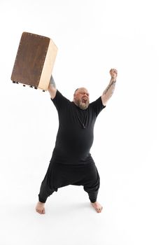 Funn caucasian bearded tattoed man is posing on white background