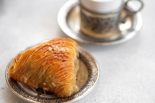 Small cup of Turkish coffee and Turkish baklava on table