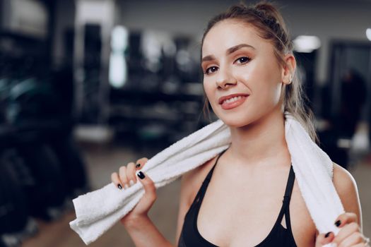 Portrait of a young sporty caucasian woman training in a fitness club close up