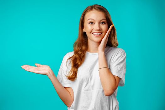 Shocked and amazed young woman with funny face expression close up