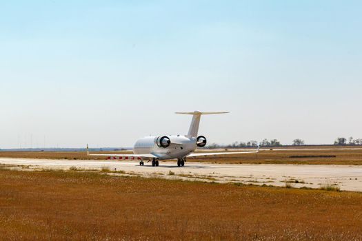 Passenger plane taking off from runway at airport on sunny day photo