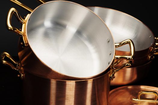 Set of copper cookware over dark background. High quality photo