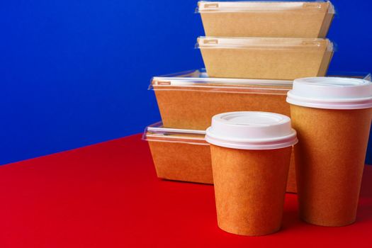 Takeaway food concept. Some packed food in container with coffee cup on table