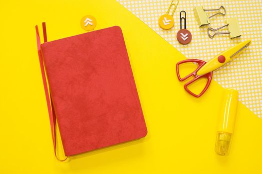 School supplies. Yellow and red colors. Flat lay composition. Yellow background. Space for text. Back to school.