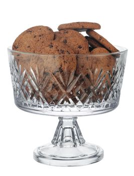 Glass cookie jar with chocolate chip cookies inside isolated on white background