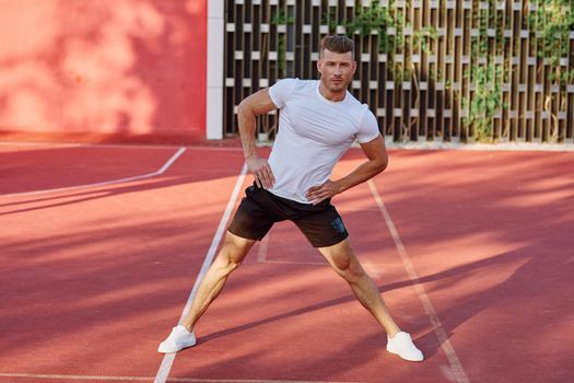 man on the sports ground exercise warm-up lifestyle. High quality photo