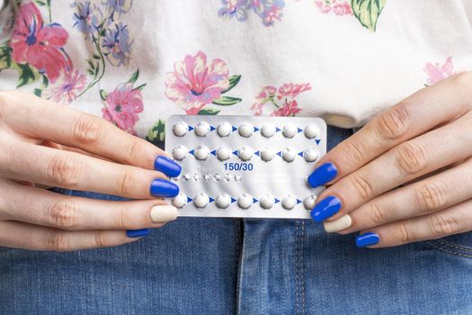 close up woman holding pills tablet
