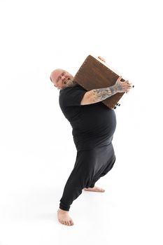 Funn caucasian bearded tattoed man is posing on white background