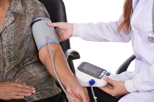 close-up of Female doctor measuring blood pressure of senior woman