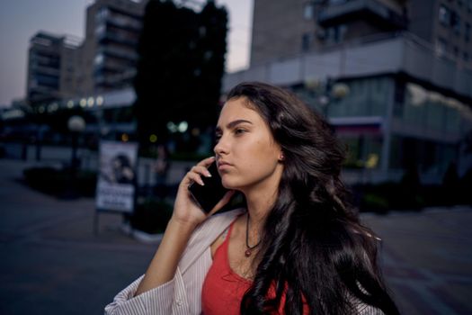 woman with phone in her hands outdoors walk lifestyle summer. High quality photo