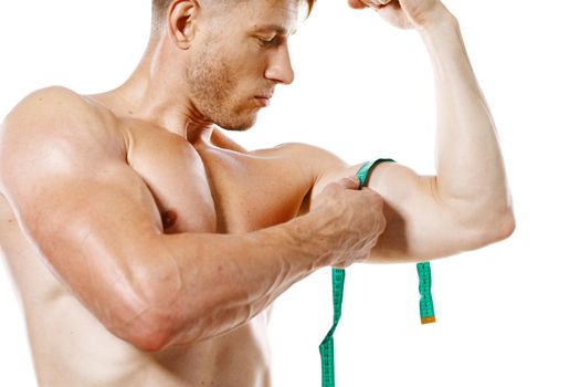 athletic man with measuring tape muscle workout. High quality photo