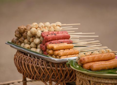 The grilled sausage and meat ball in Thai style at market