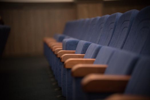 Empty blue row of seats, chairs. Perspective view, nobody
