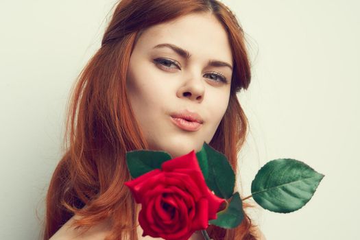 beautiful red-haired woman rose flower close-up charm. High quality photo