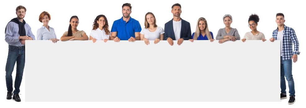 Happy large group of casual people standing together and holding a blank sign for your text